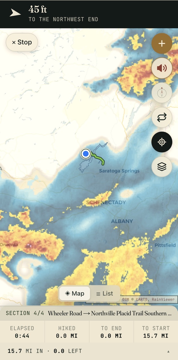 Trail navigation with the rain-radar overlay on: a storm system sweeping the map near Saratoga Springs, the trail drawn in green, voice and recenter controls, and section stats — elapsed time, miles hiked, to end, to start.
